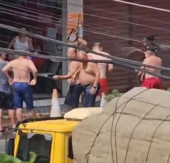 Homens tomam banho de mangueira na porta de bar para espantar calor no ES
